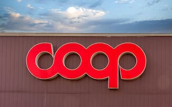 Savigliano, Italy - January 14, 2022: Sign with logo Coop, it is a italian cooperative of consumers and supermarkets of large-scale distribution of fo