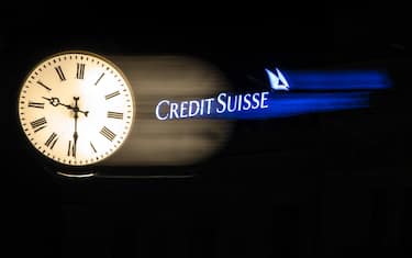epa10531016 The illuminated logo of Swiss bank Credit Suisse is seen behind a clock at the bank's headquarters at Paradeplatz in Zurich, Switzerland, 18 March 2023. Shares of Credit Suisse lost more than one-quarter of their value on 15 March 2023, hitting a record low after its biggest shareholder, the Saudi National Bank, told outlets that it would not inject more money into the ailing Swiss bank. Its shares recovered briefly on 16 March after Switzerland's central bank announced that it was to loan CS money but fears of turmoil in the global banking sector persist.  EPA/MICHAEL BUHOLZER