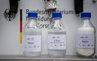 06 November 2019, Baden-Wuerttemberg, Eggenstein-Leopoldshafen: Bottles containing water, e-fuel and synthetic wax are located on the northern campus of the Karlsruhe Institute of Technology (KIT) in a research facility that can produce CO2-neutral fuel from air and green electricity using "Power-to-X" technologies (P2X). The plant was officially put into operation. Photo: Marijan Murat/dpa (Photo by Marijan Murat/picture alliance via Getty Images)