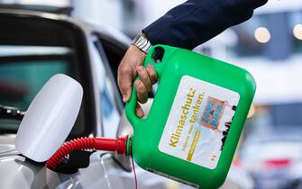 20 September 2021, Baden-Wuerttemberg, Stuttgart: A car is refuelled with a canister with the inscription "Klimaschutz könnte man Tanken - E-Fules for Future" at a petrol station during an E-Fuels test drive as part of Stuttgart Mobility Week. Photo: Tom Weller/dpa (Photo by Tom Weller/picture alliance via Getty Images)