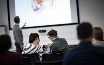 Students using digital tablet at a lecture