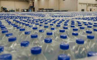 Thousands of water bottles are stored in warehouse