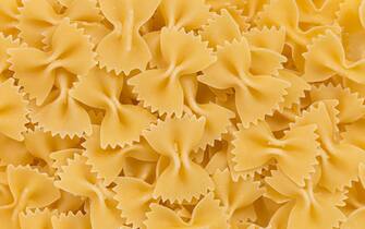 Close up of uncooked farfalle pasta as a background