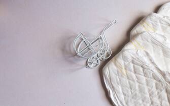Baby diapers with a toy carriage on a white background