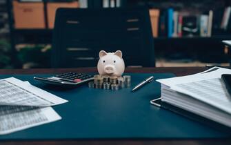 money and  piggy bank on the table. Business saving money and financial concept.
