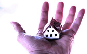 1487184290 Model of a house in a hand (Photo by: Universal Archive/Universal Images Group via Getty Images)