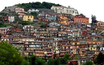 Traditional painted houses stand on a hillside in the town of Rocca di Papa, Italy, on Wednesday, May 15, 2013. The Italian government won't need to make more budget cuts this year to finance a plan to ease taxes, and it remains committed to suspending payment of an unpopular property levy, Finance Minister Fabrizio Saccomanni said. Photographer: Alessia Pierdomenico/Bloomberg via Getty Images