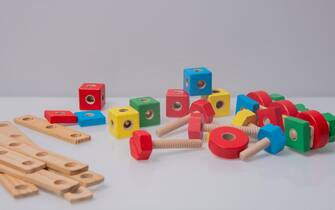 Wooden parts for the assembly of the designer. Child play with a toy desinger of the children room. kindergarden games.
