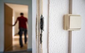 12 May 2023, Saxony, Zwickau: Traces of a burglary can be seen on an apartment door in a vacant building in the Eckersbach district of Zwickau. Several doors and heating pipes were damaged during a break-in on Thursday evening. The prefabricated building is to serve as refugee accommodation in the future. Photo: Kristin Schmidt/dpa-Zentralbild/dpa (Photo by Kristin Schmidt/picture alliance via Getty Images)
