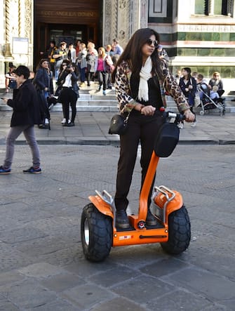 FLORENCE, ITALY - NOVEMBER 3, 2015: A tourist rides her rented Segway Personal Transporter in the Piazza de Duomo in Florence, Italy. (Photo by Robert Alexander/Getty Images)