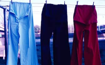 601249299 Infrared photo of blue, black, and red pants hanging on a clothesline, Juarez, Mexico, late 1980s. (Photo by Mark Jay Goebel/Getty Images)