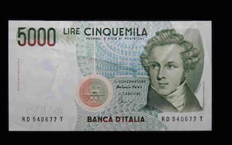 View of a 5,000 (Cinquemila) Italian Lira banknote (replaced by the Euro in 2002) on a black background.