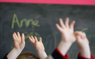 GLASGOW, SCOTLAND - JANUARY 28: Children wave their hands at a private nursery school January 28, 2005 in Glasgow, Scotland. The average price of pre-school care has increased over the past year, sending child care prices to an average of GBP200 in parts of the southeast. Many working parents in the UK have called for pre-school childcare subsidies such as those in France where nearly 100% of three-year-olds are in pre-school education, despite the fact that school attendance is not compulsory until they turn five. (Photo by Christopher Furlong/Getty Images)