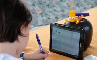 MILAN, ITALY - MAY 06: Fourth grade student Nicolo, 10, son of the photographer, uses a tablet to participate in an E-learning class with his teacher and classmates while at home on May 06, 2020 in Milan, Italy. Italy will remain on lockdown to stem the transmission of the Coronavirus (Covid-19), slowly easing restrictions.  (Photo by Pier Marco Tacca/Getty Images)