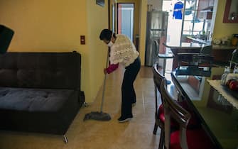 Mexican housekeeper Maria del Carmen Hernandez, 59, cleans at her home in Mexico City, on June 24, 2020. - In March, when the new coronavirus outbroke in latin America, many domestic workers were sent home without payment, others were laid off and others confined in the homes where they work. (Photo by CLAUDIO CRUZ / AFP) (Photo by CLAUDIO CRUZ/AFP via Getty Images)
