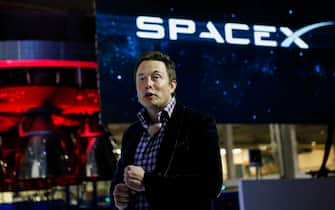 Elon Musk, chief executive officer of Space Exploration Technologies Corp. (SpaceX), speaks at the unveiling of the Manned Dragon V2 Space Taxi in Hawthorne, California, U.S., on Thursday, May 29, 2014. The Dragon V2 manned space taxi, an upgraded version of the unmanned spacecraft Dragon, will be capable of sending a mix of cargo and up to seven crew members to the International Space Station. Photographer: Patrick T. Fallon/Bloomberg via Getty Images 