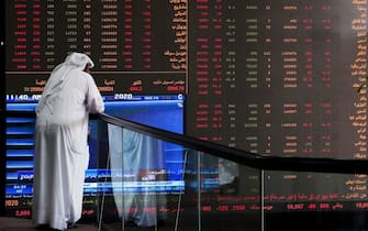 TOPSHOT - A Kuwaiti trader checks stock prices at Boursa Kuwait in Kuwait City, on March 8, 2020. - Kuwait Boursa authorities stopped trading after the Premier Index slumped 10 percent while the All-Shares index dived 8.4 percent, as shares in the energy-dependent Gulf plunged to multi-year lows after OPEC's failure to agree on a coronavirus action plan prompted fears of an all-out oil price war. (Photo by YASSER AL-ZAYYAT / AFP) (Photo by YASSER AL-ZAYYAT/AFP via Getty Images)