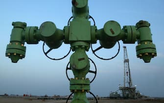 ON NORTHERN BORDER BETWEEN IRAQ AND KUWAIT, KUWAIT - JANUARY 22:  A wellhead is shown in front of a Kuwait Oil Company drilling rig January 22, 2003 on the northern border between Iraq and Kuwait in Kuwait. Kuwait produces approximately ten percent of the worlds oil and the country has promised to increase production, as needed, in the event of a war in Iraq.  (Photo by Joe Raedle/Getty Images)
