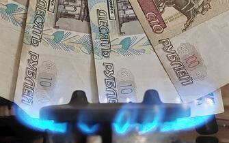 Flames from a gas burner on a cooker and Russian roubles are seen on March 24, 2022 in this illustration photo for paying a gas in Russian roubles, in Sibenik, Croatia. President Vladimir Putin said on Wednesday that Russia will seek payment in roubles for gas sold to "unfriendly" countries. Photo: Dusko Jaramaz/PIXSELL