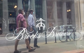 CHICAGO, ILLINOIS - JULY 08: The Brooks Brothers logo is painted on the window of a shuttered store in the financial district on July 08, 2020 in Chicago, Illinois. The retailer which was founded in 1818 and currently has more than 500 stores worldwide filed for bankruptcy protection today.  (Photo by Scott Olson/Getty Images)