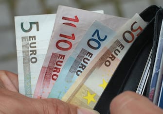 BERLIN, GERMANY - JUNE 21:  In this photo illustration a man removes Euro currency bills from a wallet on June 21, 2011 in Berlin, Germany. Eurozone finance ministers are currently seeking to find a solution to Greece's pressing debt problems, including the prospect of the country's inability to meet its financial obligations unless it gets a fresh, multi-billion Euro loan by July 1. Greece's increasing tilt towards bankruptcy is rattling worldwide financial markets, and leading economists warn that bankruptcy would endanger the stability of the Euro and have dire global consequences.  (Photo Illustration by Sean Gallup/Getty Images)