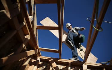 PETALUMA, CA - JANUARY 21:  A worker carries lumber as he builds a new home on January 21, 2015 in Petaluma, California. According to a Commerce Department report, construction of new homes increased 4.4 percent in December, pushing building of new homes to the highest level in nine years.
(Photo by Justin Sullivan/Getty Images)