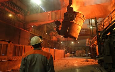 SALZGITTER, GERMANY - MARCH 05: A worker watches as a ladle recedes after pouring molten iron into a converter for creating steel at the Salzgitter AG steelworks on March 05, 2019 in Salzgitter, Germany. Salzgitter produces a wide variety of steel products, including galvanized flat steel used for cars and appliances.  (Photo by Sean Gallup/Getty Images)