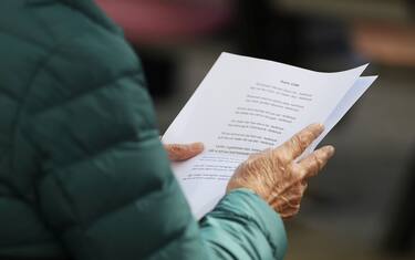 STOCKHOLM, SWEDEN - MAY 21: A woman reads a psalm from a disposable paper instead from a psalm book as she takes part in the Ascension Day Church Service at Gustav Vasa Church on May 21, 2020 in Stockholm, Sweden. Sweden, a country of about 10 million people, has maintained more of an open society as it grappled with the coronavirus pandemic. It is one of several European countries observing the Ascension Day public holiday on Thursday. (Photo by Linnea Rheborg/Getty Images)