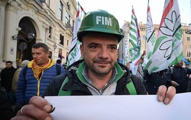 A worker affiliated to the FIM metalworkers union joins other workers and unions from all sectors coming from all over Italy, particularly from the South (Mezzogiorno) for a protest in downtown Rome on December 10, 2019, against the industrial crisis, the closure of factories, lay-offs and for public and private investment, best working conditions and social protection. - Italy is negotiating a new plan with the world's biggest steelmaker ArcelorMittal to save the Taranto steel plant that involves partial state ownership, the Italian Prime Minister said on December 9. (Photo by Vincenzo PINTO / AFP) (Photo by VINCENZO PINTO/AFP via Getty Images)