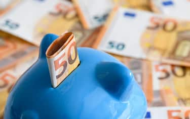 DORTMUND, GERMANY - APRIL 10: (BILD ZEITUNG OUT) In this photo illustration a blue piggy bank is seen in the bottom left corner with a 50 Euro bill. It looks at 50 Euro notes lying in the background on April 10, 2020 in Dortmund, Germany. (Photo by Alex Gottschalk/DeFodi Images via Getty Images)
