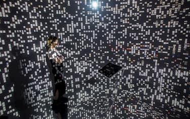 ISTANBUL, TURKEY - MAY 06:  A woman views historical documents and photographs displayed in a high tech art installation at Salt Galata on May 6, 2017 in Istanbul, Turkey. The "Archive Dreaming" installation by artist Refik Anadol uses artificial intelligence to visualize nearly 2 million historical Ottoman documents and photographs from the SALT Research Archive. Controlled by a single tablet in the center of a mirrored room the artist used machine learning algorithms to combine historical documents, art, graphics and photographs to create an immersive installation allowing people to scroll, read and explore the archives. The SALT Galata archives include around 1.7 million documents ranging from the late-Ottoman era to the present day. The exhibition is on show at SALT Galata art space through till June 11, 2017.  (Photo by Chris McGrath/Getty Images)