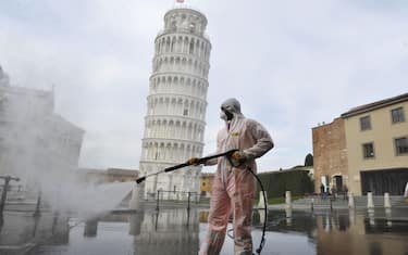 PISA, ITALY - MARCH 17:  A worker carries out sanitation operations for the Coronavirus emergency in Piazza dei Miracoli near to the Tower of Pisa in a deserted town on March 17, 2020 in Pisa, Italy. The sanitization service is carried out by four teams in all the districts of the city of Pisa, to sanitize the squares, streets, public areas, sidewalks, surfaces exposed to the contact of large flows of people. Italian government has imposed unprecedented restrictions on its 60 million people as it expanded its emergency Coronavirus (Covid-19) lockdown nationwide. The number of confirmed Covid-19 cases in Italy has passed 31,500 with the death toll rising to 2503.  (Photo by Laura Lezza/Getty Images)