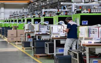 An employee works during his shift at the production line of the Codogno-based Italian multinational company MTA, specialized in electromechanical components for the automotive industry, on May 20, 2020 in Codogno, southeast of Milan, one of the villages at the epicenter of the coronavirus epidemic in February, as the country's is easing its lockdown aimed at curbing the spread of the COVID-19 infection, caused by the novel coronavirus. (Photo by MIGUEL MEDINA / AFP) (Photo by MIGUEL MEDINA/AFP via Getty Images)