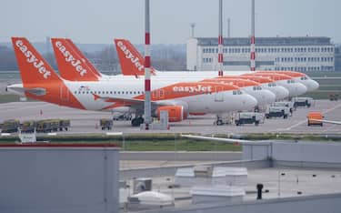 SCHOENEFELD, GERMANY - MARCH 17: Passenger planes of discount airline EasyJet stand on the tarmac at Berlin-Schoenefeld Airport on March 17, 2020 in Schoenefeld, Germany. EasyJet and competitor Ryanair have announced they will likely ground significant numbers of their planes in response to airport closures and a collapse in reservations due to the global coronavirus pandemic. Other airlines have made similar announcements. (Photo by Sean Gallup/Getty Images)