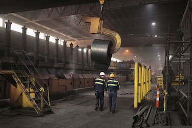 PORTAGE, IN - MARCH 15:  Workers remove a coil from the production line for quality-control testing during steel production at the NLMK Indiana steel mill on March 15, 2018 in Portage, Indiana. The coils, which are custom made to customer specifications, weigh an average of nearly 25 tons. The mill, which is projected to produce up to 1 million tons of steel from recycled scrap in 2018, is considered a "mini mill" by U.S standards. NLMK Indiana is a subsidiary of NLMK, one of Russia's largest steel manufacturers, responsible for nearly a quarter of Russias steel production. Steel producers in the U.S. and worldwide are preparing for the impact of the recently-proposed tariffs by the Trump administration of 25 percent on imported steel.  (Photo by Scott Olson/Getty Images)