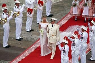 MONACO - JULY 02:  (PREMIUM RATES APPLY)  Prince Albert II of Monaco and Princess Charlene of Monaco leave the palace after the religious ceremony of the Royal Wedding at the Prince's Palace on July 2, 2011 in Monaco. The Roman-Catholic ceremony follows the civil wedding which was held in the Throne Room of the Prince's Palace of Monaco on July 1. With her marriage to the head of state of Principality of Monaco, Charlene Wittstock has become Princess consort of Monaco and gain the title, Princess Charlene of Monaco. Celebrations including concerts and firework displays are being held across several days, attended by a guest list of global celebrities and heads of state.  (Photo by Richard Heathcote/PP/Getty Images)