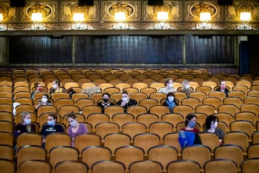 PRAGUE, CZECH REPUBLIC - MAY 11: Customers wearing protective masks sit apart in observance of social distancing measures inside a movie theater as the Czech government lifted more restrictions allowing cinemas to re-open on May 11, 2020, in Prague, Czech Republic. The Czech government has begun further easing the restrictive measures to slow down the spread of the pandemic COVID-19 disease during the lockdown. (Photo by Gabriel Kuchta/Getty Images)