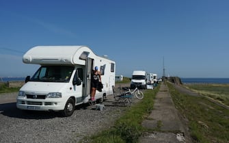 REDCAR, UNITED KINGDOM - JUNE 24: Camper vans park up at South Gare near Redcar as people enjoy the hot weather on June 24, 2020 in Redcar, United Kingdom. A summer heatwave is expected across the country this week with weather warnings issued in some places for thunderstorms. (Photo by Ian Forsyth/Getty Images)