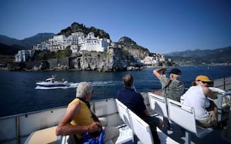 A view taken on July 2, 2020 shows tourist sail off Amalfi on the Amalfi coast in southern Italy. - With its white and multicoloured houses perched on the mountainside about the crystalline waters of the Mediterranean, Italy's Amalfi coast is suffering from this year's lack of US tourists. (Photo by Filippo MONTEFORTE / AFP) (Photo by FILIPPO MONTEFORTE/AFP via Getty Images)