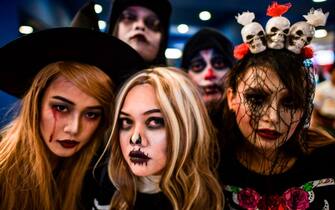 Participants wearing costumes pose for a photo during Halloween carnival at a shopping mall in Kuala Lumpur on October 27, 2018. (Photo by Mohd RASFAN / AFP)        (Photo credit should read MOHD RASFAN/AFP via Getty Images)