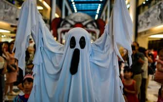 A man wearing a costume walks at a shopping mall during Halloween carnival in Kuala Lumpur on October 27, 2018. (Photo by Mohd RASFAN / AFP)        (Photo credit should read MOHD RASFAN/AFP via Getty Images)