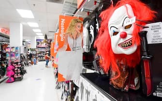 A lone shopper wearing a facemask is seen at a retail store selling Halloween merchandise on October 14, 2020 in Alhambra, California, during the ongoing coronavirus pandemic. - Trick-or-Treating for Halloween in California this year has been "strongly discouraged" across the state due to the threat of coronavirus. (Photo by Frederic J. BROWN / AFP) (Photo by FREDERIC J. BROWN/AFP via Getty Images)