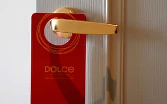 A placard hangs on a room's doorknob at the newly-inaugurated Dolce Hanoi Golden Lake hotel, the world's first gold-plated hotel, in Hanoi on July 2, 2020. (Photo by Manan VATSYAYANA / AFP) (Photo by MANAN VATSYAYANA/AFP via Getty Images)