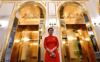 A staff member stands near the lifts in the lobby of the newly-inaugurated Dolce Hanoi Golden Lake hotel, the world's first gold-plated hotel, in Hanoi on July 2, 2020. (Photo by Manan VATSYAYANA / AFP) (Photo by MANAN VATSYAYANA/AFP via Getty Images)