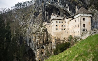 Predjama Castle, situated in the middle of a cliff near Postojna Cave, is the largest cave castle in the world