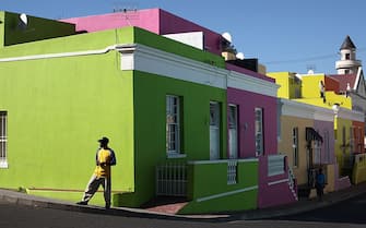 CAPE TOWN, SOUTH AFRICA - OCTOBER 20:  A man walks through the Bo-Kaap area of Cape Town on October 20, 2009 in Cape Town, South Africa. The Bo-Kaap area is a predominantly Muslim area of Cape Town with brightly coloured painted houses that line many of the streets..  (Photo by Dan Kitwood/Getty Images)