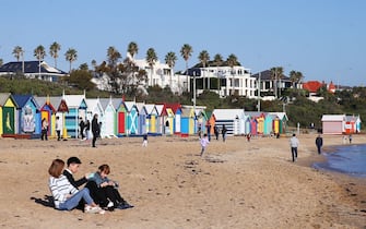 MELBOURNE, AUSTRALIA - MAY 14:  Tourists take photos at the bathing boxes on Brighton Beach on May 14, 2018 in Melbourne, Australia. The spot is popular with locals and tourists and is often used as an iconic Australian setting.  (Photo by Michael Dodge/Getty Images)