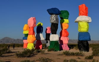 The 'Seven Magic Mountains' art installation by Swiss artist Ugo Rondinone stand in the Ivanpah Valley near Las Vegas, Nevada, on May 22, 2017.
The seven towers of colorfully stacked boulders, stand more than 30 feet high (9 meters) and are a stark contrast to the Mojave Desert environment that they occupy. / AFP PHOTO / Mark RALSTON / RESTRICTED TO EDITORIAL USE - MANDATORY MENTION OF THE ARTIST UPON PUBLICATION - TO ILLUSTRATE THE EVENT AS SPECIFIED IN THE CAPTION        (Photo credit should read MARK RALSTON/AFP via Getty Images)