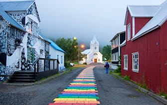 Seydisfjordur, Austurland, Iceland, August 05, 2019: Seydisfjordur is a small town with colorful  buildings  in Eastern Iceland, on a fjord the same name. This peculiar brick rainbow was born as a form of support for the LGTBI collective.