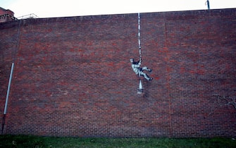 1231458835 An artwork which has appeared on the wall of the former prison in Reading, Berkshire. Picture date: Monday March 1, 2121. PA Photo. Although its has not been officially claimed as the work of Banksy, the picture bares a resemblance to the artists other works. Photo credit should read: Steve Parsons/PA Wire (Photo by Steve Parsons/PA Images via Getty Images)